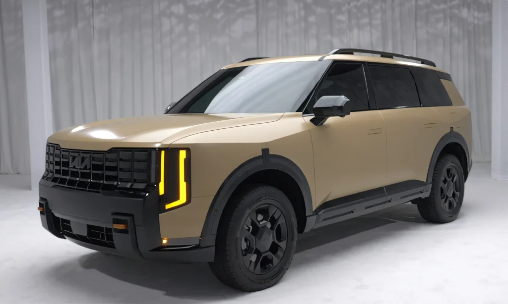 2027 Kia Telluride in orange camouflage wrap showing vertical headlights