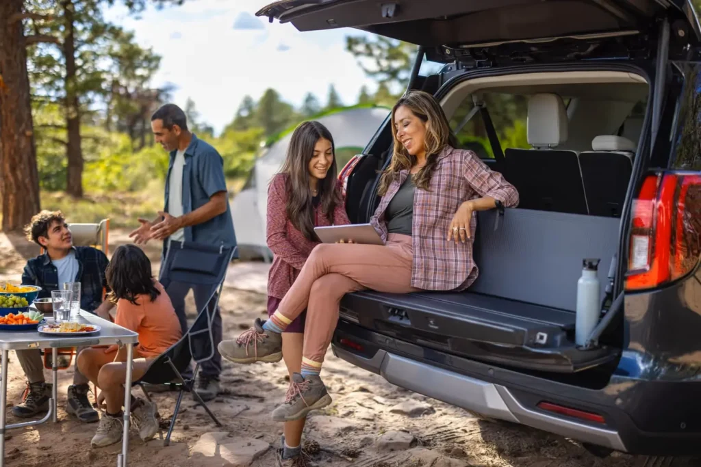 A family enjoying the Split Gate feature of the 2025 Ford Expedition while camping