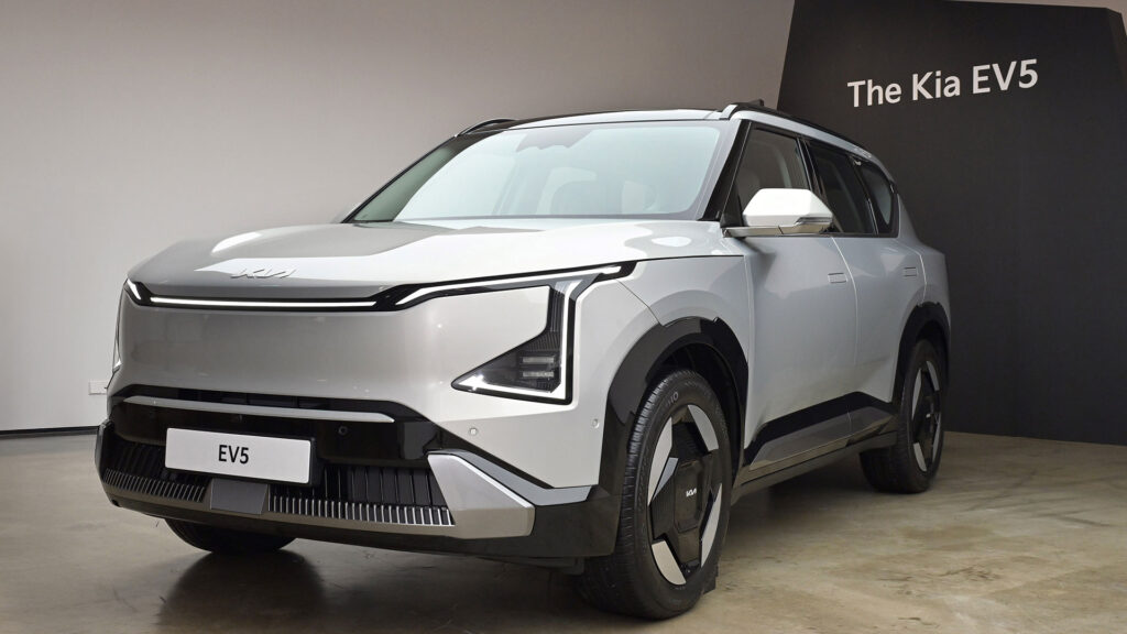 Silver Kia EV5 parked in a showroom, illustrating the 400V system limitation and FWD architecture.