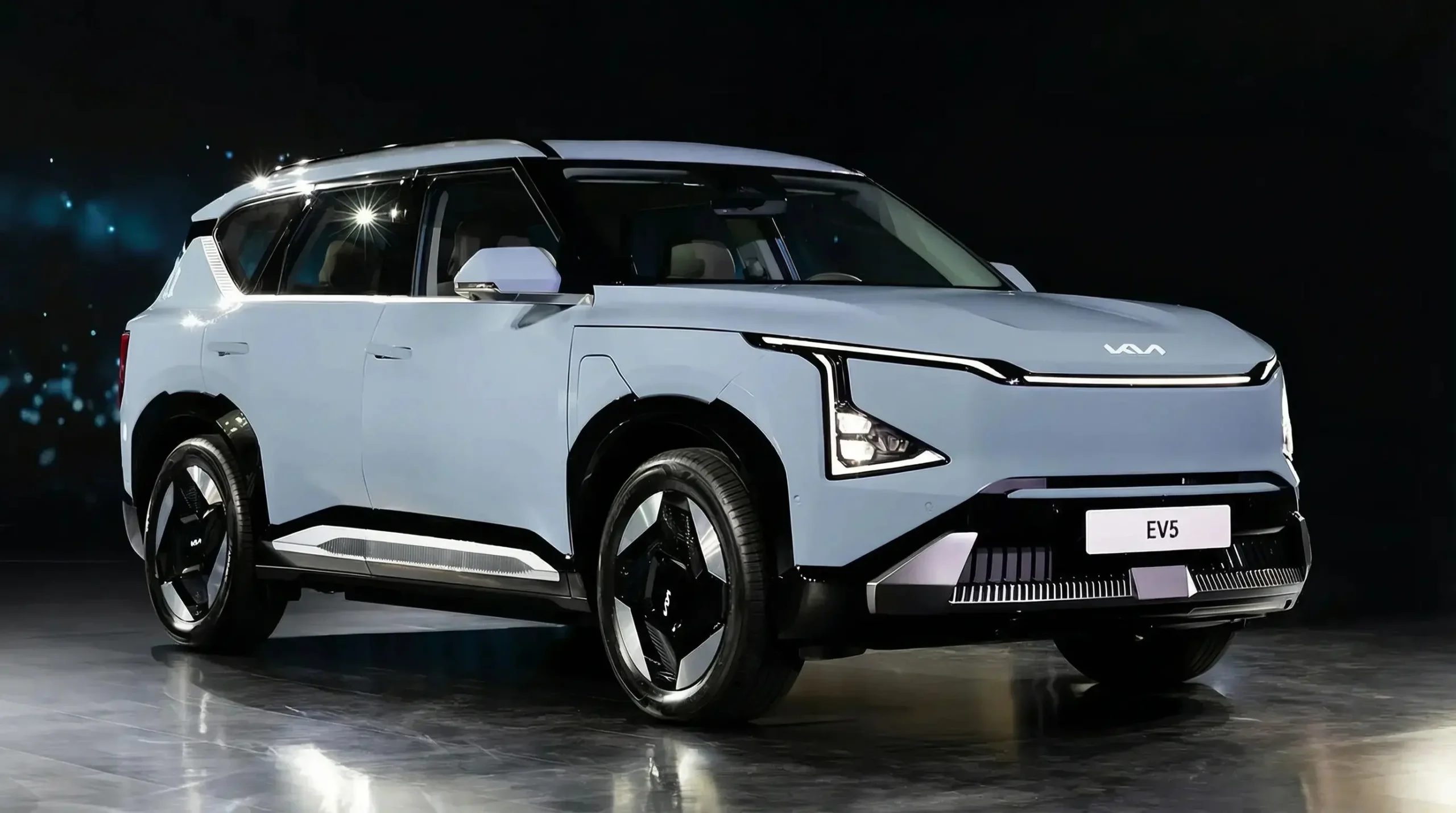 Kia EV5 compact electric SUV front view in dark studio lighting, showcasing "Digital Tiger Face" design.